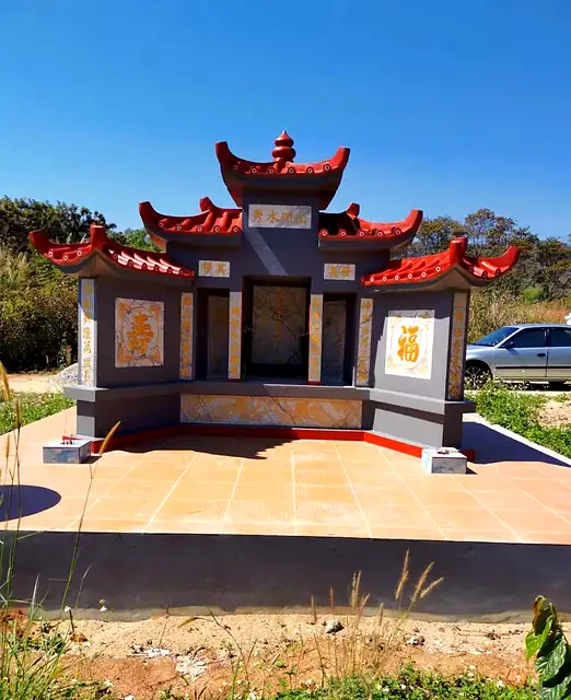 Dark grey Chinese tomb with red roof and tiled floor