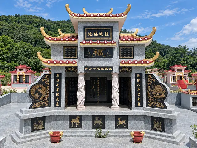 Granite Chinese tomb with traditional roofs among green hills