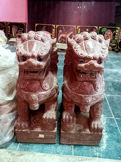 Pair of red granite lions