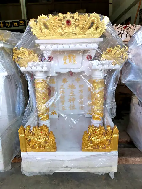 White marble shrine with gold dragon pillars
